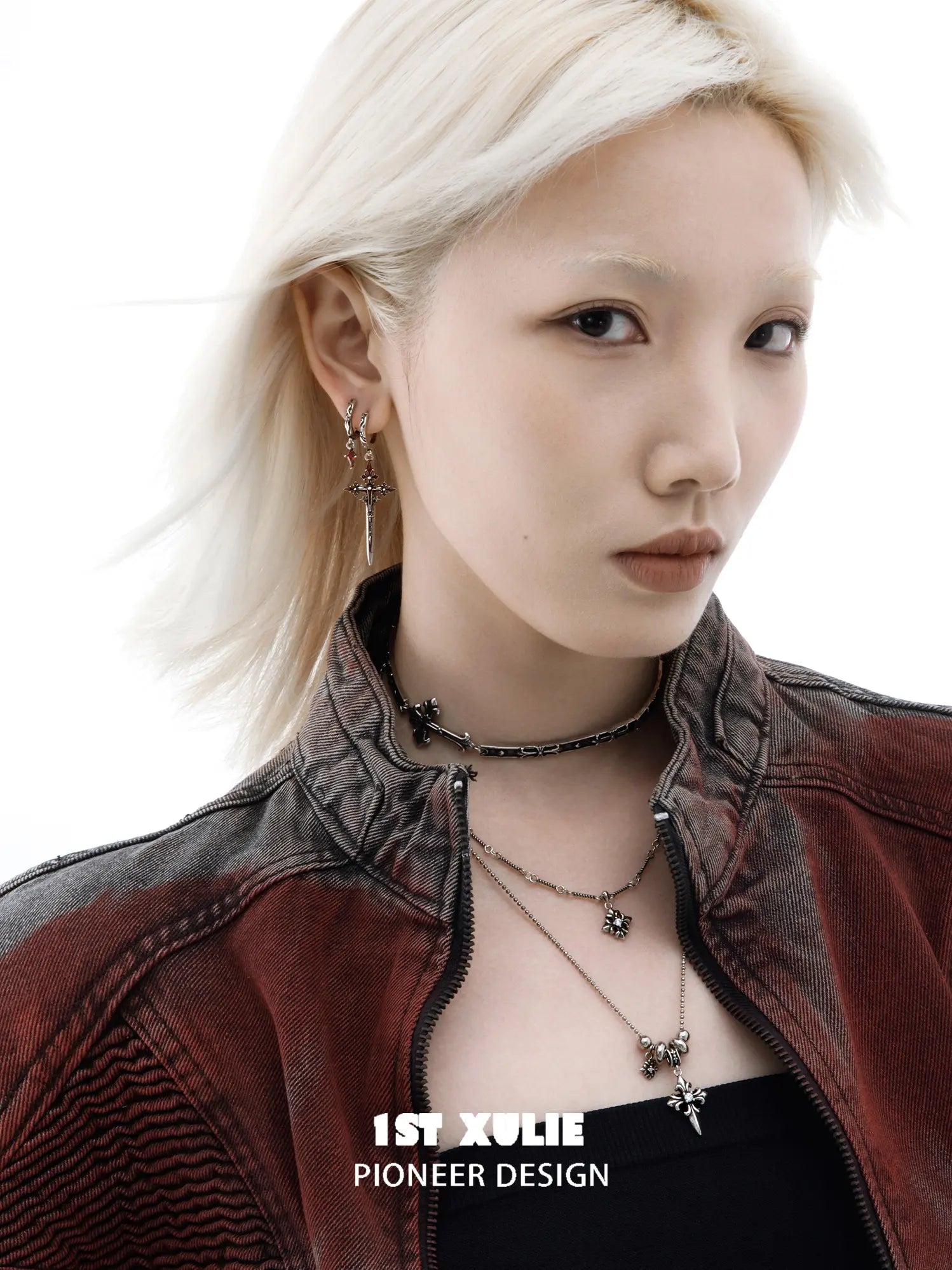 Red drop and dagger hoop earrings worn together on the ear