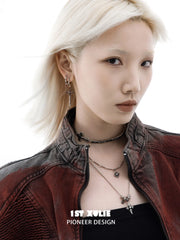 Red drop and dagger hoop earrings worn together on the ear