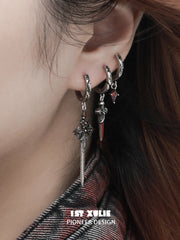 Side close-up of the red drop and dagger hoops