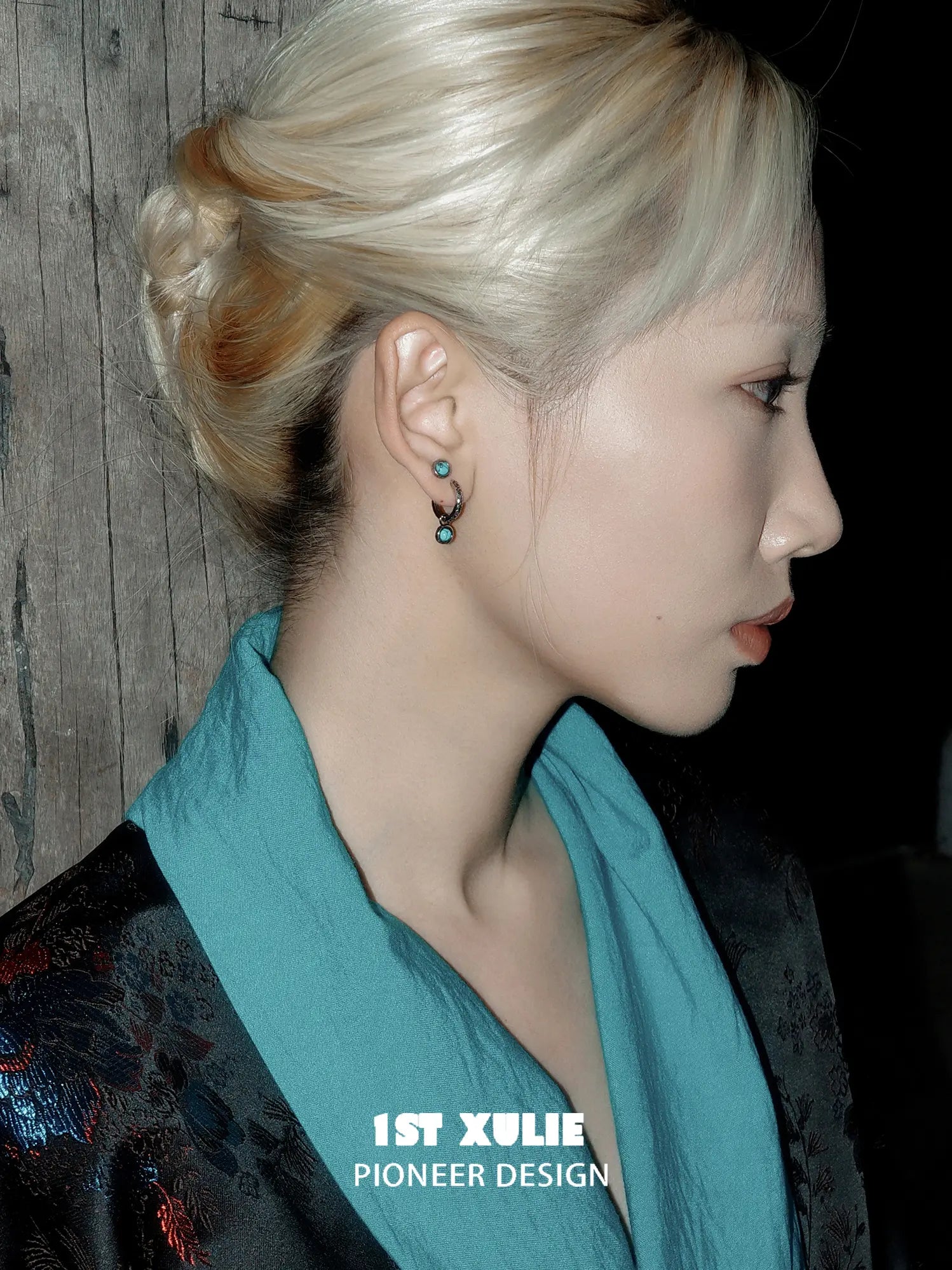 Side portrait showing the turquoise drop earring