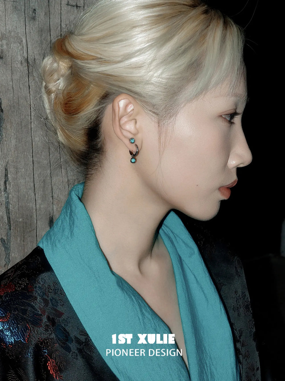 Side portrait showing the turquoise drop earring
