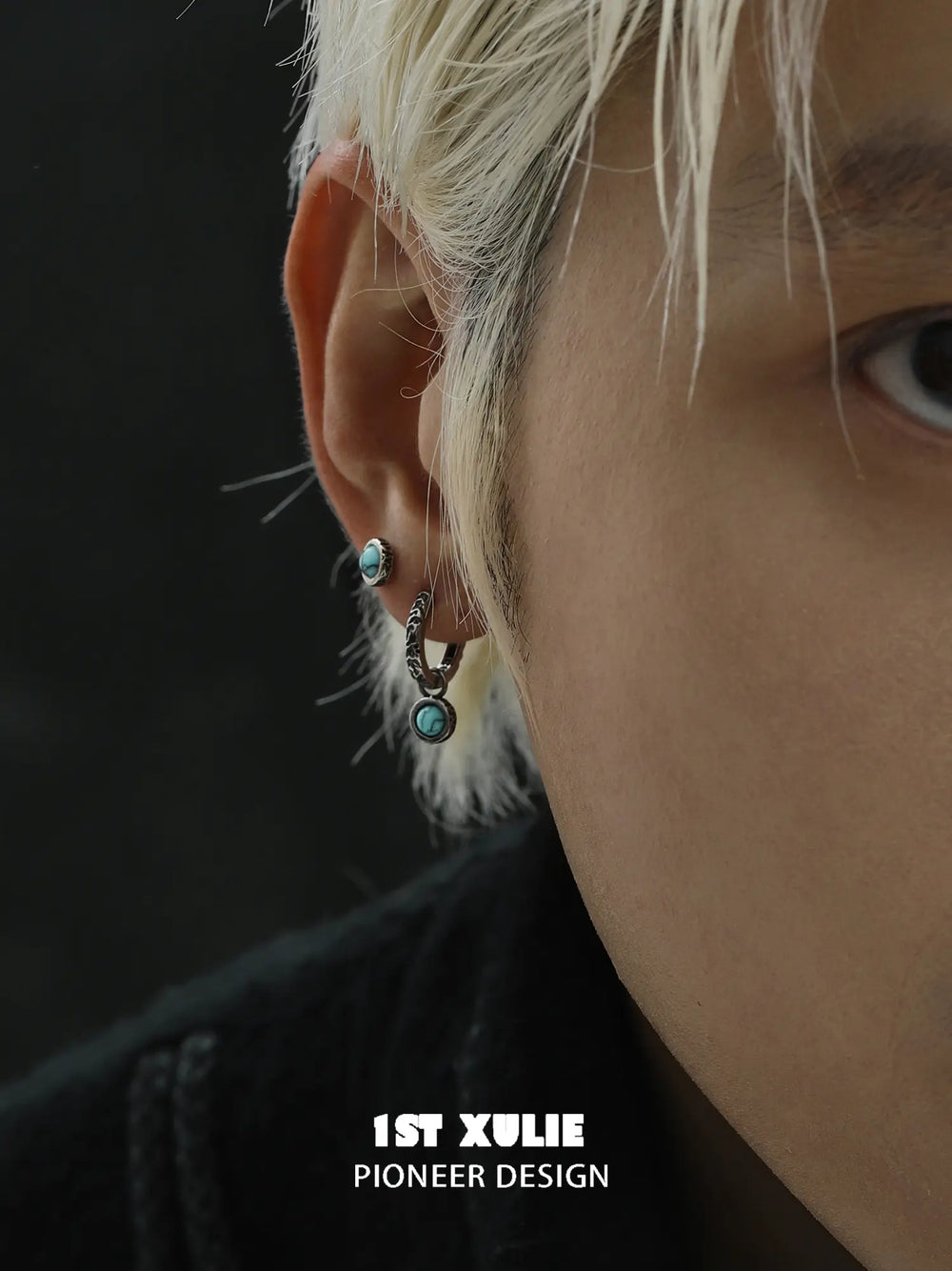 Close view of a turquoise stud and drop hoop worn together