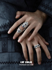 Wide blue woven open ring worn with coordinating jewelry