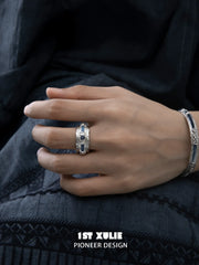 Wide blue woven open ring worn with coordinating jewelry